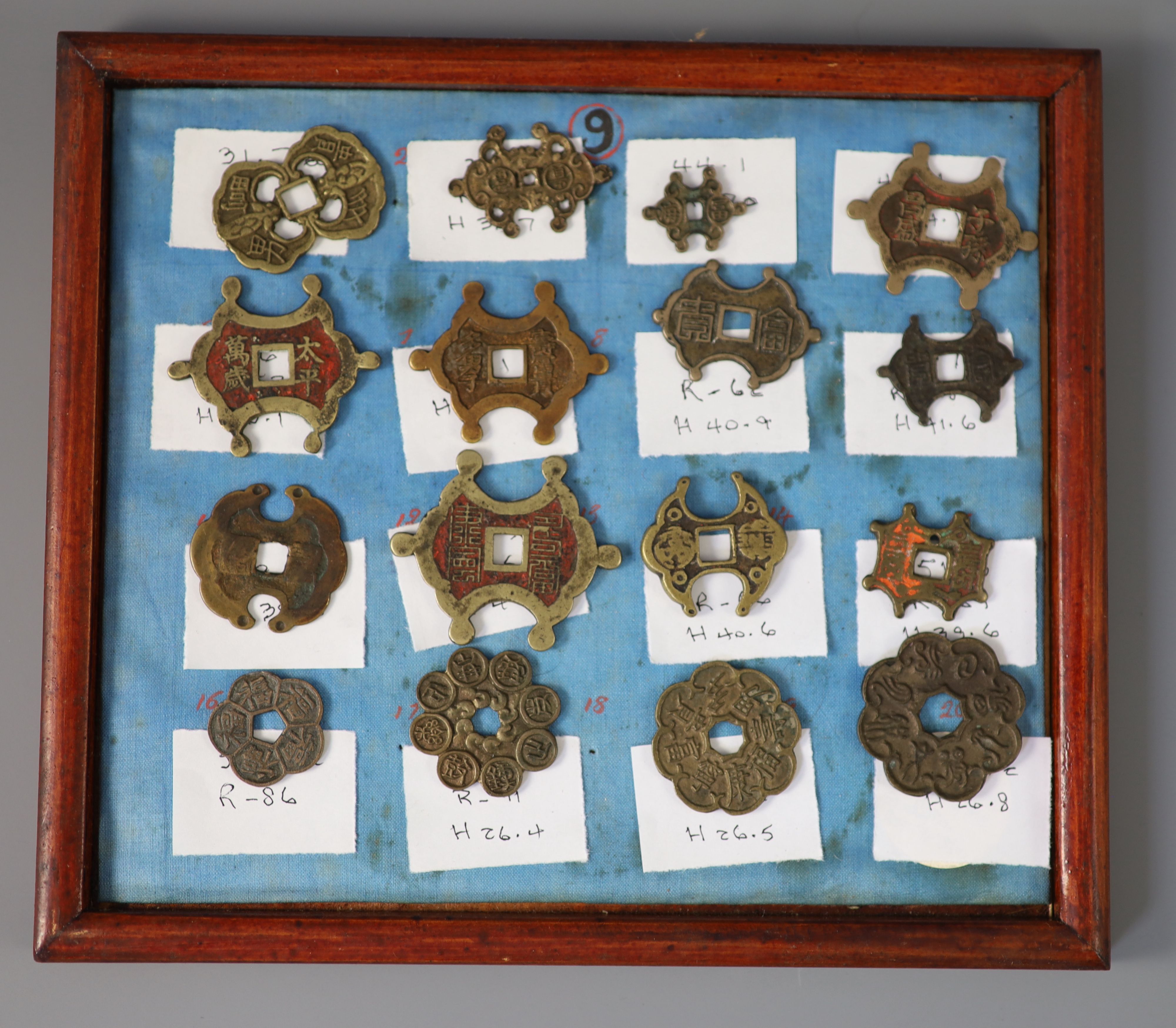 A group of 99 Korean bronze and metal amulets or charms, 19th/20th century